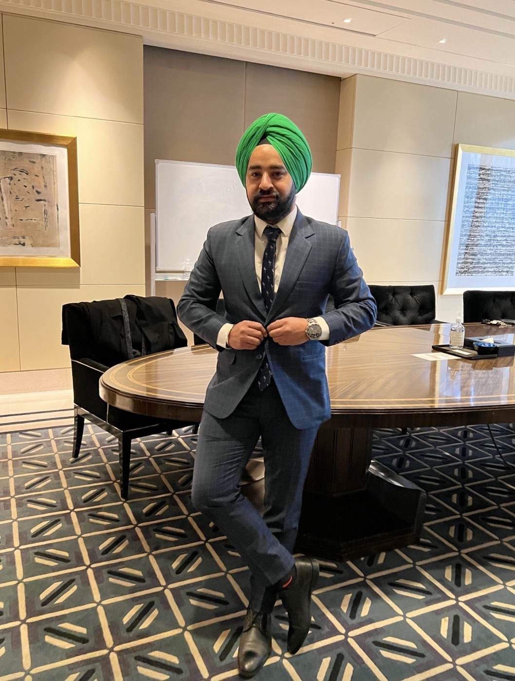 Raj Pahwa in a blue suit in a boardroom