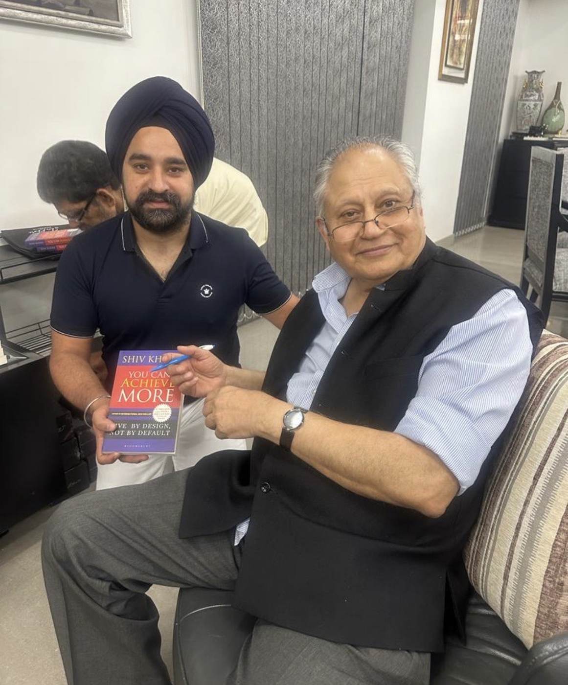 Raj Pahwa with author Shiv Khera, holding his book You Can Achieve More