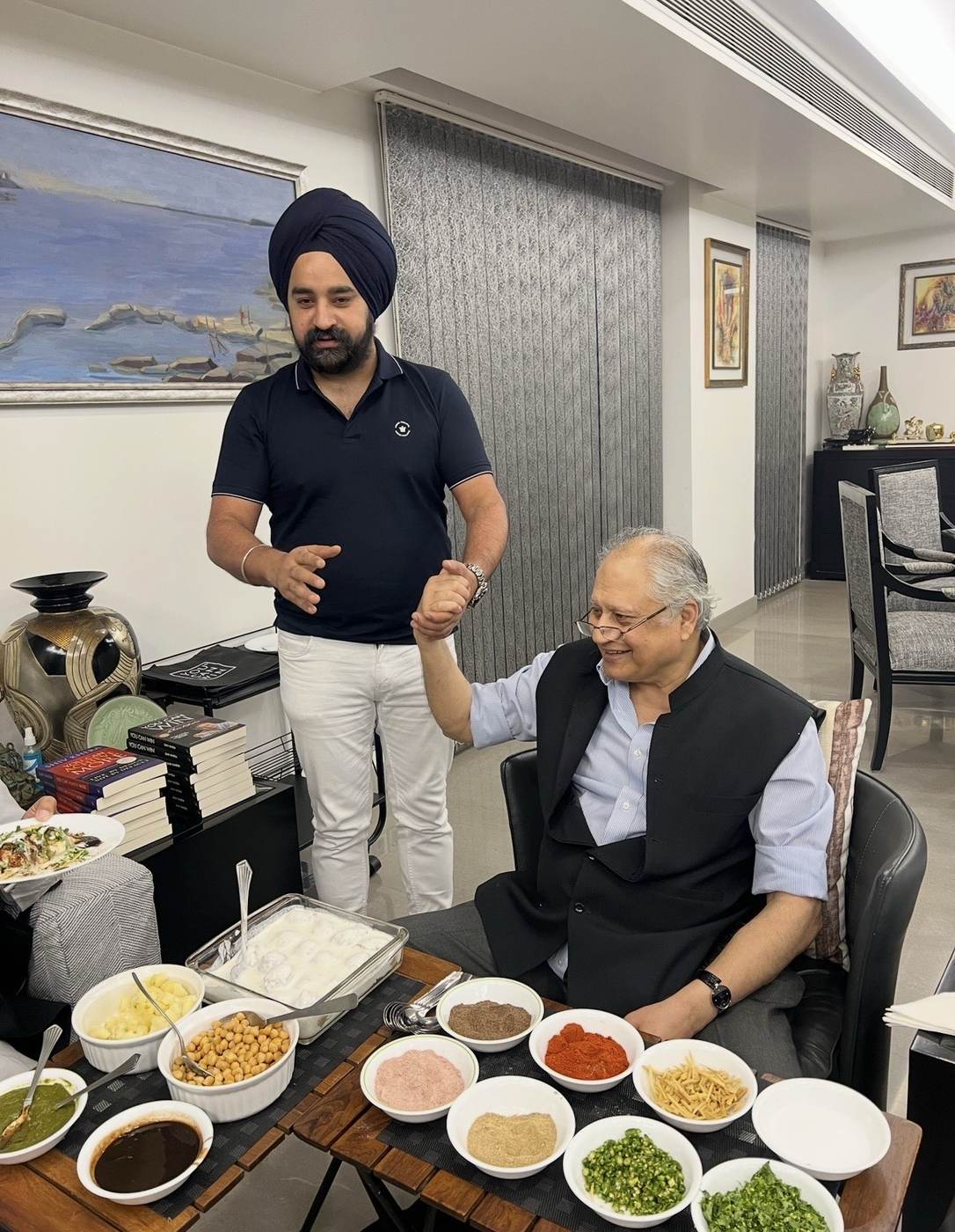 Raj Pahwa sharing a meal with author Shiv Khera