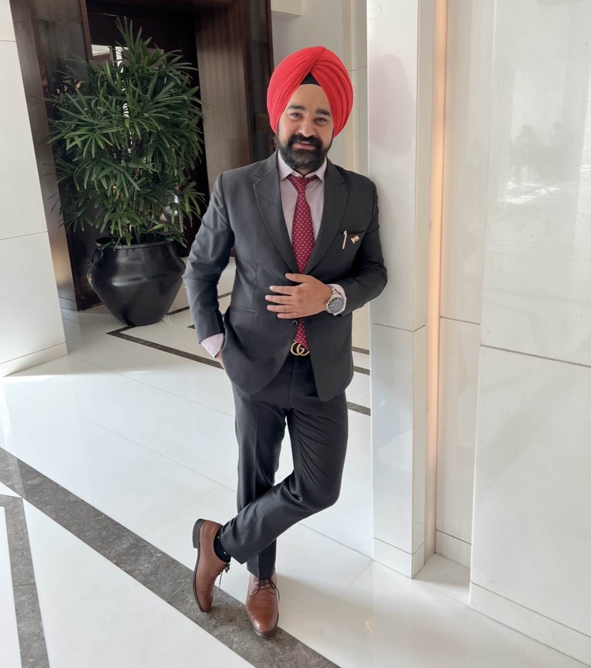 Raj Pahwa in a grey suit and red tie